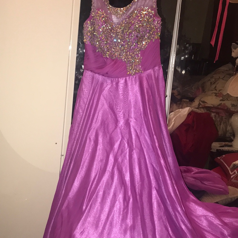 A purple prom dress with a flowy and long end